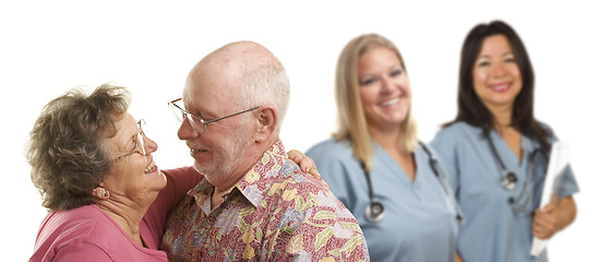 Image showing Senior Couple with Medical Doctors or Nurses Behind