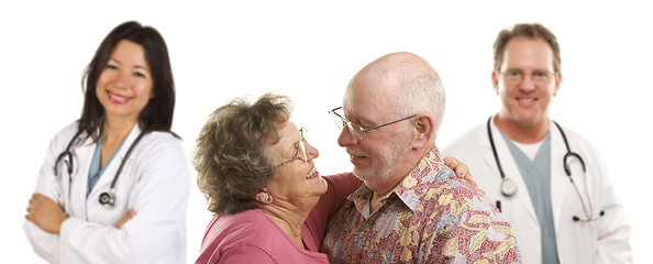 Image showing Senior Couple with Medical Doctors or Nurses Behind