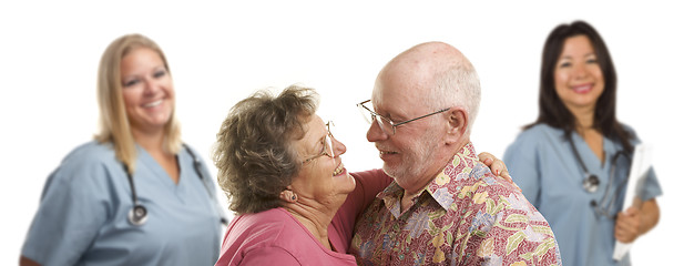 Image showing Senior Couple with Medical Doctors or Nurses Behind