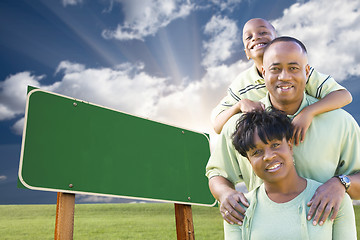 Image showing African American Family in Front of Blank Green Road Sign