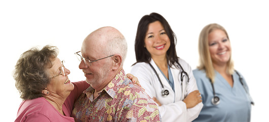 Image showing Senior Couple with Medical Doctors or Nurses Behind