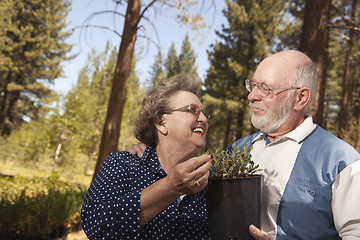 Image showing Attractive Senior Couple Overlooking Potted Plants