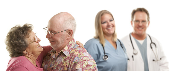 Image showing Senior Couple with Medical Doctors or Nurses Behind