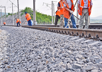 Image showing railway embankment, rails and workers