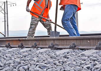 Image showing railway embankment, rails and workers