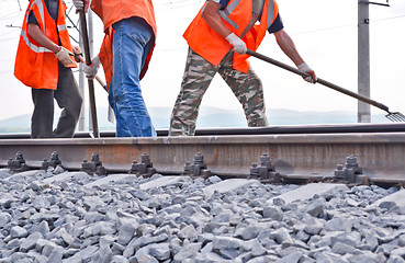 Image showing railway embankment, rails and workers