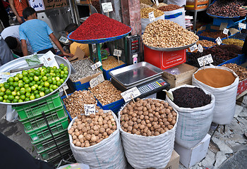 Image showing spices and nuts on the scales and dishes in an old bazaar