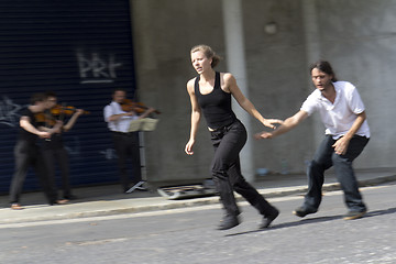 Image showing Dancers running in the street