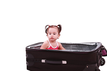 Image showing little girl sitting in suitcase 