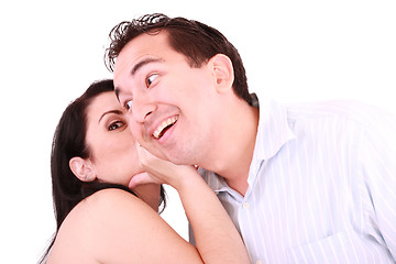 Image showing pretty girl talking secret to young man in his ear, man smiling 