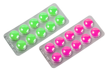 Image showing Two metallic blister with purple and green pills