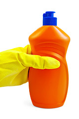 Image showing A bottle of orange in yellow-gloved hand in the