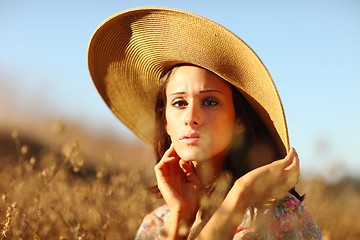 Image showing Young Beautiful Woman on a Field in Summer Time