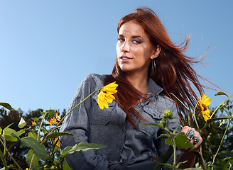 Image showing Red Haired Woman Outdoors in a Sunflower Field