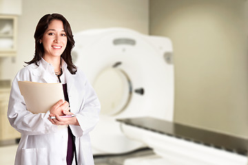 Image showing Female doctor radiologist at CT CAT scan with chart