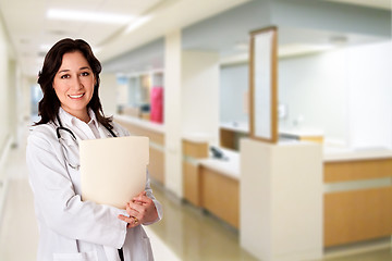 Image showing Happy Doctor with patient chart file dossier in hospital