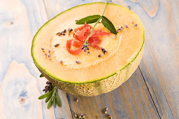 Image showing fresh melon soup with parma ham and lavender flower