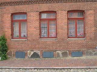 Image showing three red windows