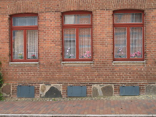 Image showing three red windows