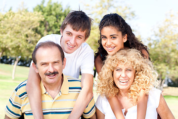 Image showing Parents giving kids piggy back ride