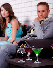 Image showing Annoyed young couple in bar or night club