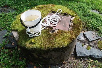 Image showing typical concrete water well with moss