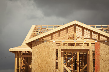 Image showing Home Construction Framing with Ominous Clouds