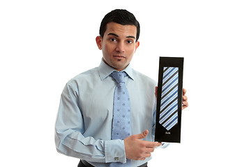 Image showing Salesman holding a tie