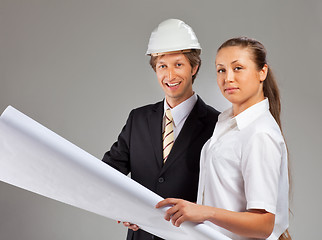 Image showing An architect wearing a hard hat and co-worker