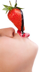 Image showing girl eating strawberry with chocolate sauc