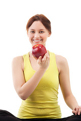 Image showing woman in sportswear with apple