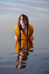 Image showing girl posing in the Water at sunset