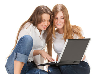 Image showing two young happy student girl work on laptop