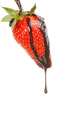 Image showing Isolated strawberry with chocolate sauce