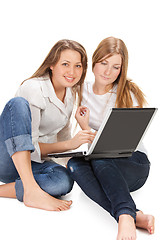 Image showing two young happy student girl work on laptop