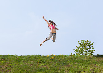 Image showing Happy young woman jumping