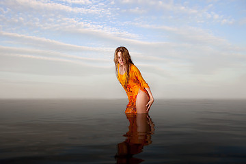 Image showing girl posing in the Water at sunset