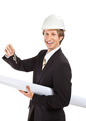 Image showing smiling engineer giving keys from apartment