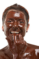 Image showing young woman having a chocolate face mask