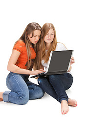 Image showing two young happy student girl work on laptop