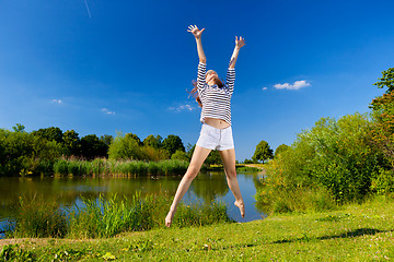 Image showing young woman exercising outdoor in summer