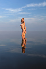 Image showing girl posing in the Water at sunset,