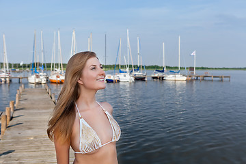 Image showing Attractive young woman near the yachts