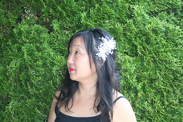 Image showing Woman in profile with flower in her hair