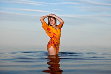 Image showing girl posing in the Water at sunset