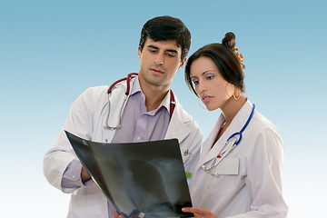 Image showing Two doctors conferring over x-ray results