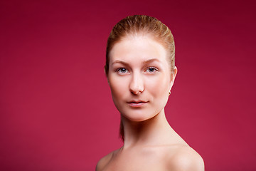 Image showing Portrait of a young lady on red