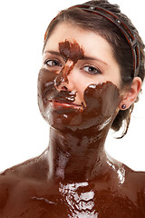 Image showing young woman having a chocolate face mask