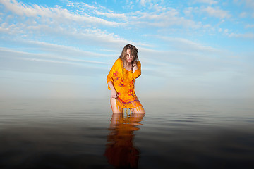 Image showing girl posing in the Water at sunset