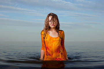 Image showing girl posing in the Water at sunset